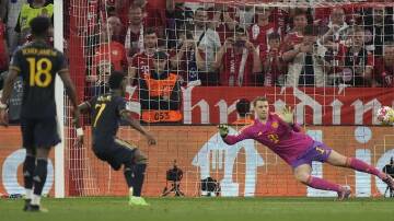Real Madrid's Vinicius Junior (second left) scores from the penalty spot against Bayern Munich. (AP PHOTO)