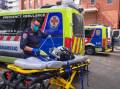 An ambulance arrived at the clinic with a fake patient during the minister's visit. (Luis Ascui/AAP PHOTOS)